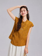 Model wearing a golden mulberry silk top with butterfly jacquard motifs, Mandarin collar and side ties.