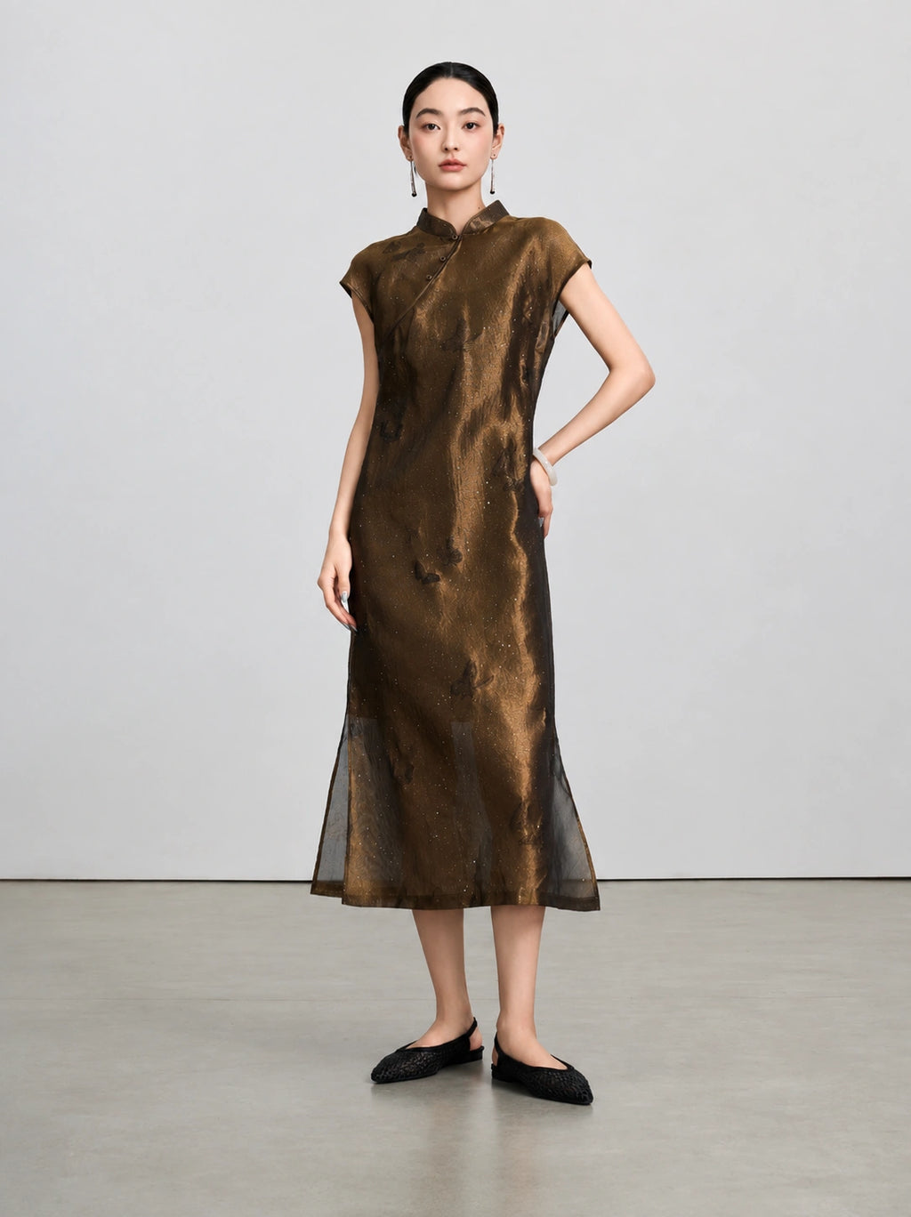 Model wearing the bronze-brown shimmering butterfly qipao with its coordinating slip