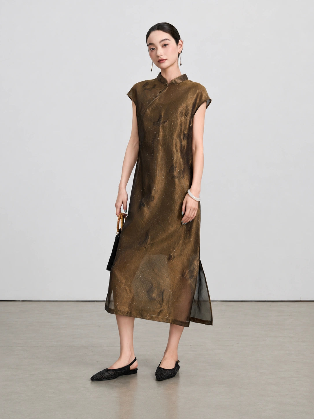 Upper-body view of the bronze-brown qipao with a stand collar and diagonal frog-button detail