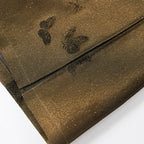 Close-up of the translucent silk-blend fabric with woven butterflies and fine sparkling accents