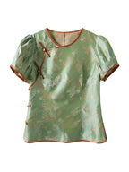 Gambiered Silk jade green Shu brocade silk top with butterfly and floral motifs, a round neck and knotted buttons