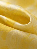 Close-up of lustrous champagne-gold mulberry silk jacquard with tonal floral texture.