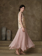 Side view showing the relaxed silhouette and side slit of the sleeveless jacquard vest