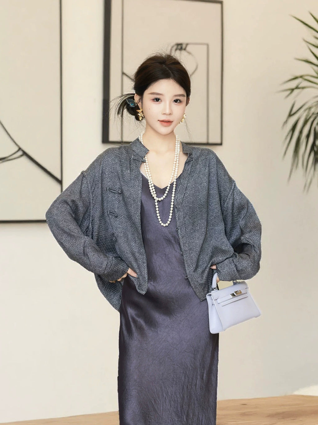 Model wearing a relaxed charcoal mulberry silk jacket with long straight sleeves