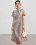 Front view of the light lavender jacquard silk A-line qipao styled with an ivory handbag