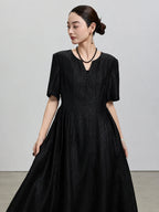 Front view of the black Hei Gui Xiangyunsha silk dress with a V-neck and sculpted waist