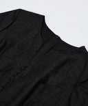 Close-up of the neckline construction, concealed zipper and tonal covered buttons