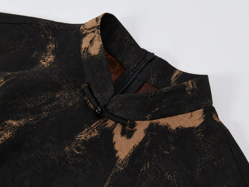 Close-up of the stand collar, frog-button closure and textured floral Xiangyunsha silk fabric