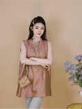 Model wearing a dusty rose Chinese-style sleeveless silk top with a relaxed fit