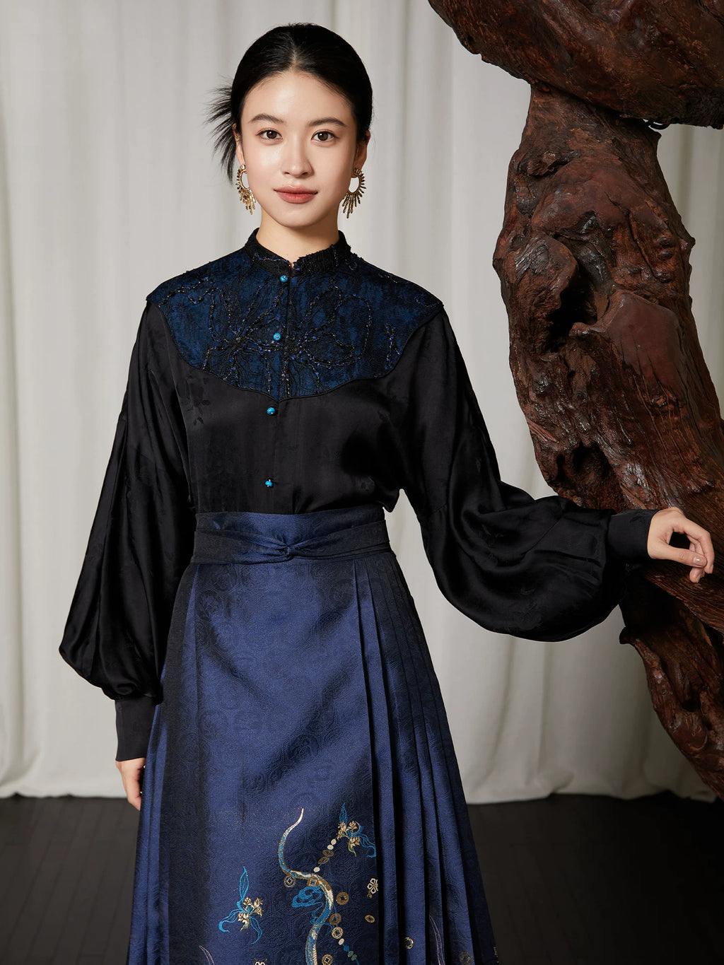 Front view of the Embroidered Mandarin Collar Viscose Blouse with embroidered yoke, Mandarin collar and long balloon sleeves.