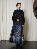 Lifestyle view of the Embroidered Mandarin Collar Viscose Blouse styled with a traditional-inspired pleated skirt.