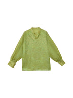 Front flat lay of a celadon green embroidered mulberry silk blouse with long sleeves and a Mandarin collar.