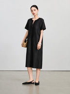 Front view of the dark aubergine silk dress with a beaded split V-neck and tonal embroidery