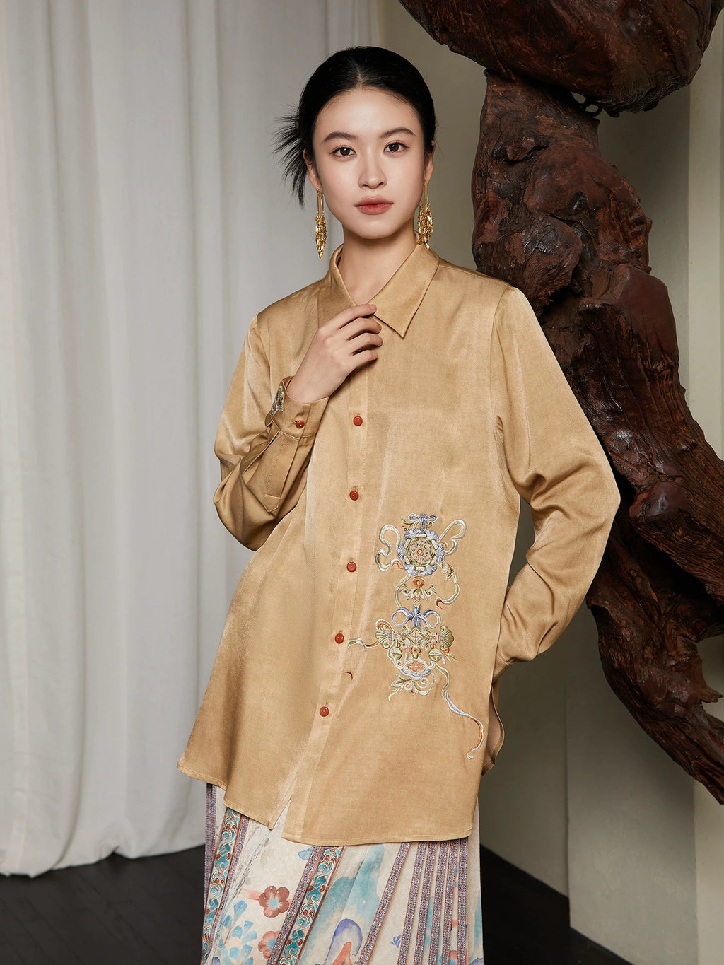 Lifestyle styling of the Embroidered Viscose Shirt paired with a printed skirt.