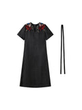 Front product view of the black Xiangyunsha dress with colorful shoulder embroidery and waist tie