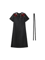 Front product view of the black Xiangyunsha dress with colorful shoulder embroidery and waist tie
