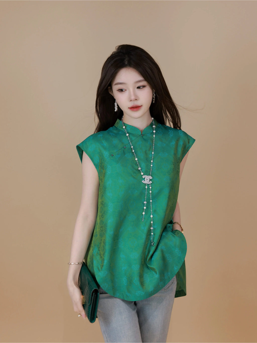 Model wearing a plum purple mulberry silk sleeveless top while seated