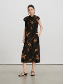 Front view of a black floral mulberry silk A-line dress with stand collar and side pockets