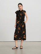 Front view of a black floral mulberry silk A-line dress with stand collar and side pockets