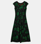 Back view of the black floral silk dress showing its gathered waist and concealed zipper.