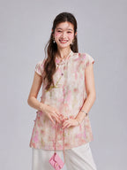 Front view of a Gambiered Silk blush pink longline top with botanical print and French-inspired floral embroidery