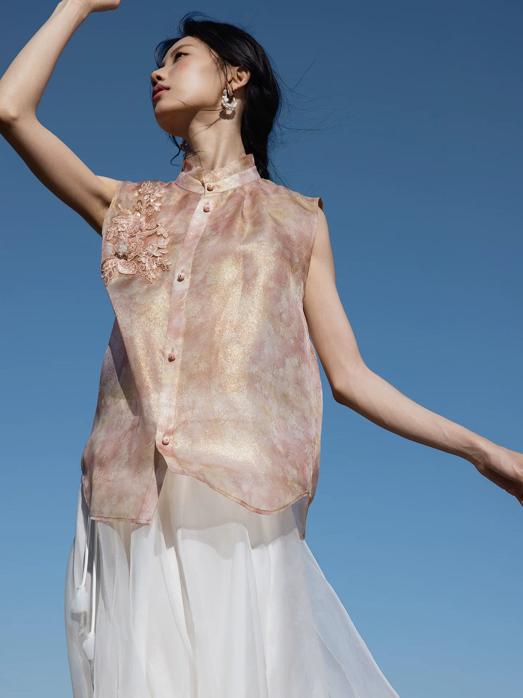 Close-up of floral embroidery on a blush pink mulberry silk sleeveless blouse by Gambiered Silk.