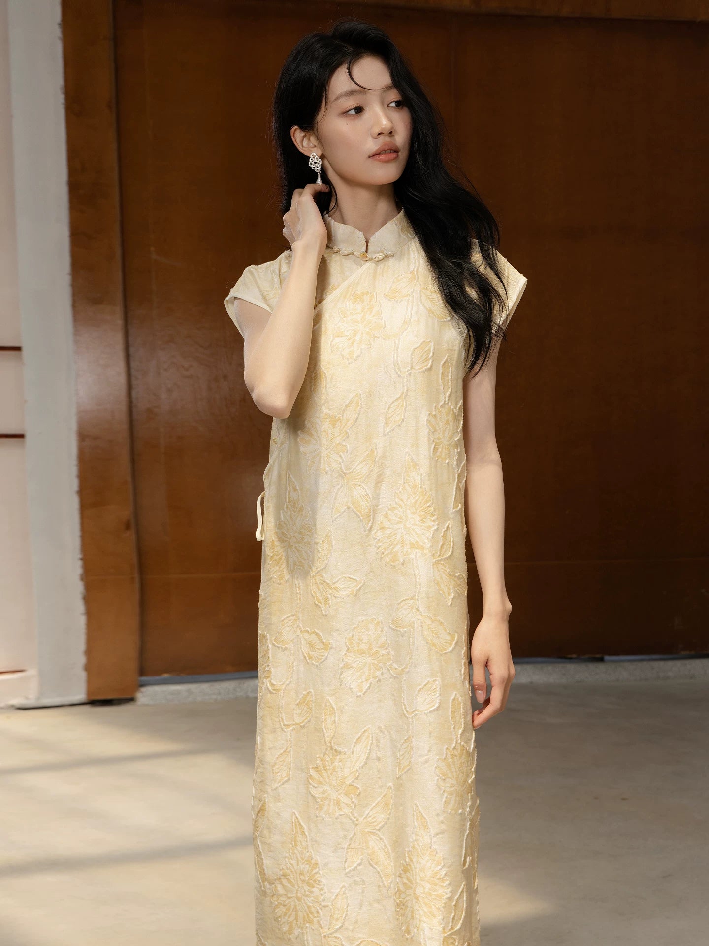 Close-up of floral textured Mandarin collar dress with handmade frog-button closure