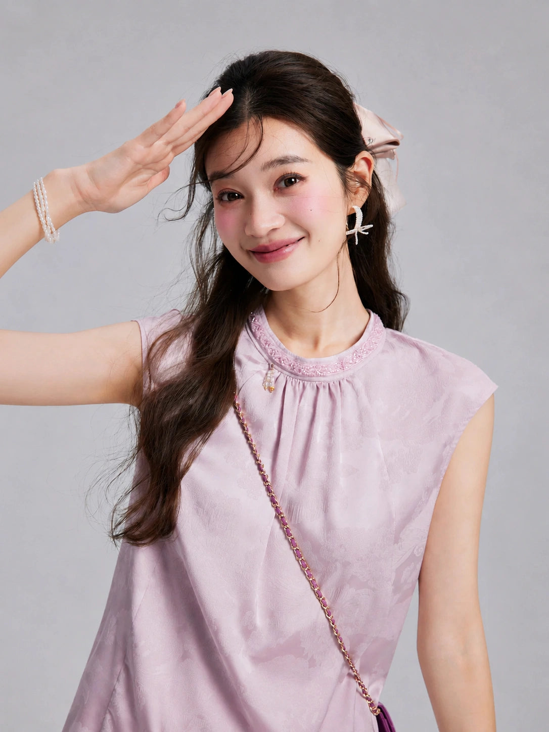 Model wearing a pale lilac sleeveless rayon top with tonal botanical jacquard and neckline beadwork.