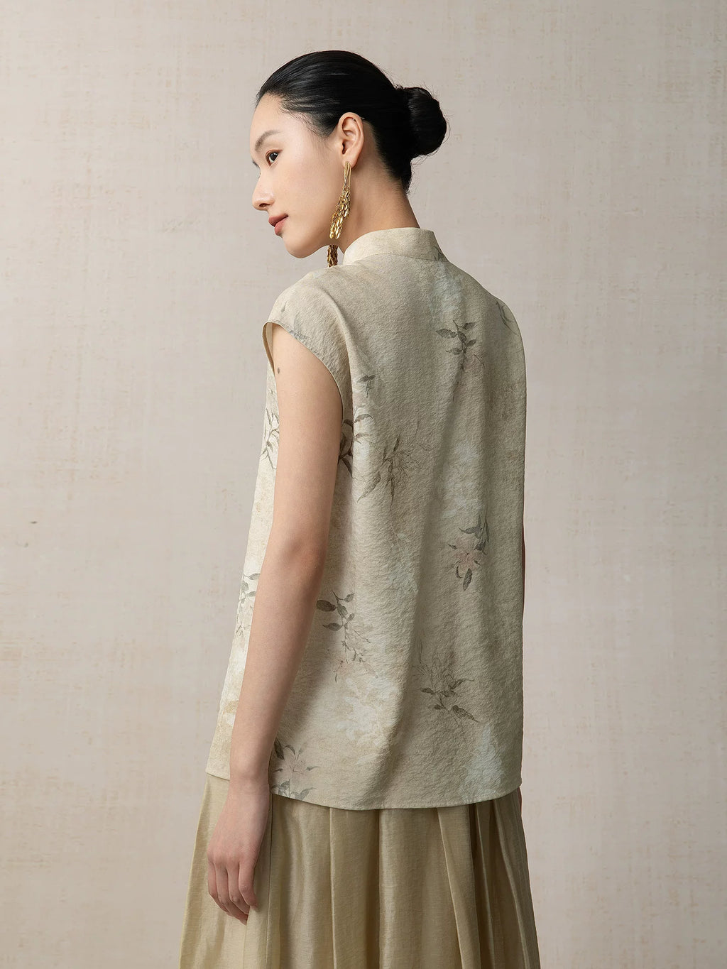 Back view of the Warm Sand floral sleeveless top with botanical print and mandarin collar by Gambiered Silk.