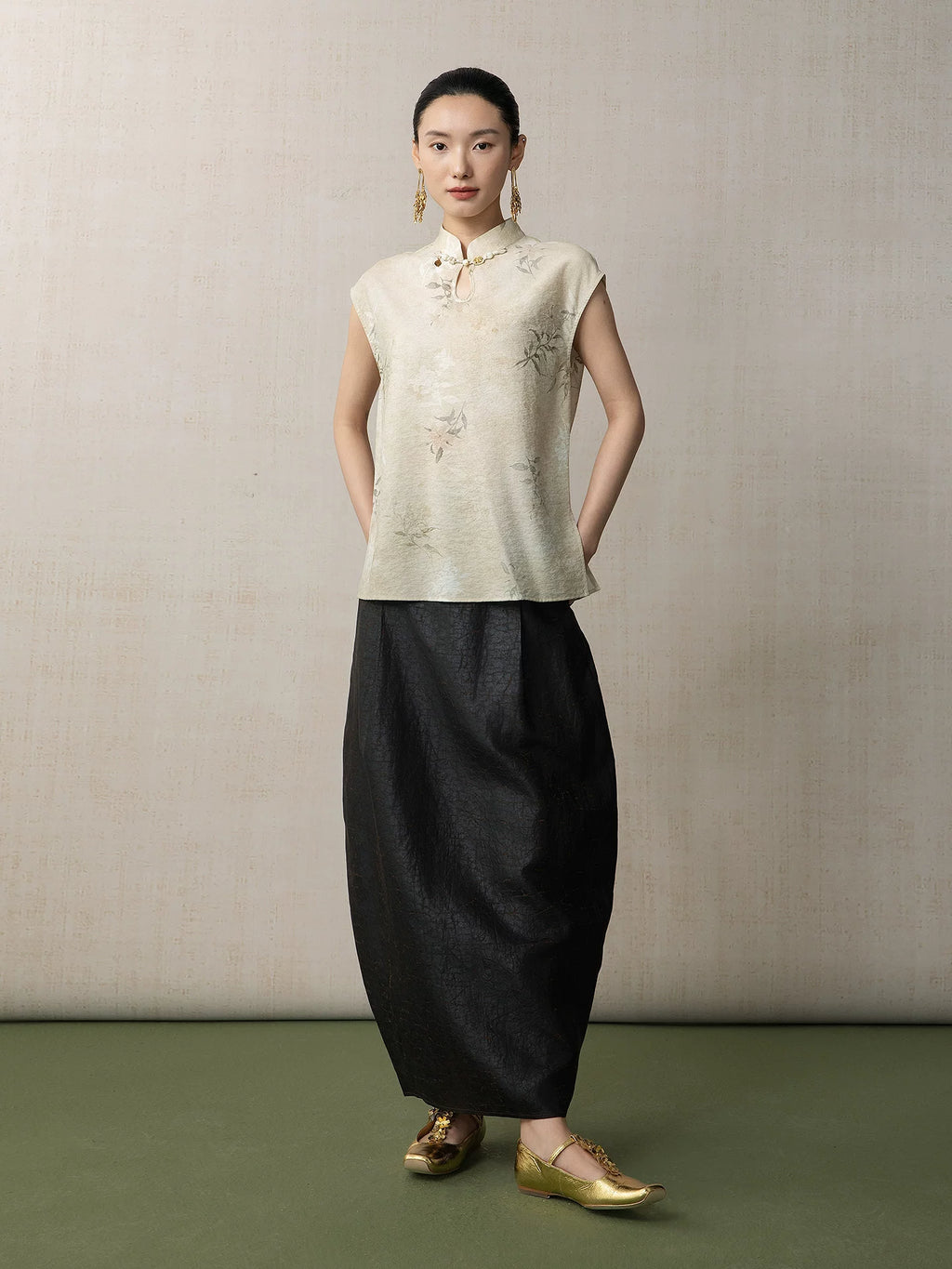 Full outfit featuring the Warm Sand floral mandarin collar sleeveless top paired with a black skirt by Gambiered Silk.