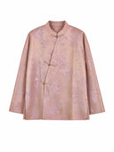 Model wearing a peach pink mulberry silk top with a mandarin collar and Chinese frog closures