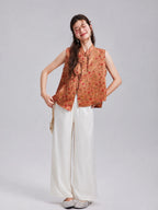 Model wearing a Gambiered Silk floral rabbit silk vest with white wide-leg trousers