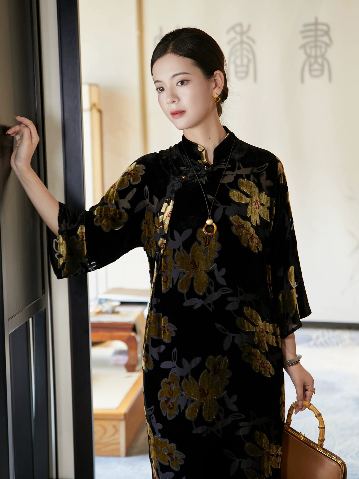 Close-up of floral velvet Mandarin collar dress featuring handcrafted frog-button closure