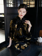 Woman wearing a floral velvet Mandarin collar midi dress in an elegant tea house setting