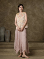 Full-length styled view of the champagne floral vest paired with a pink pleated skirt