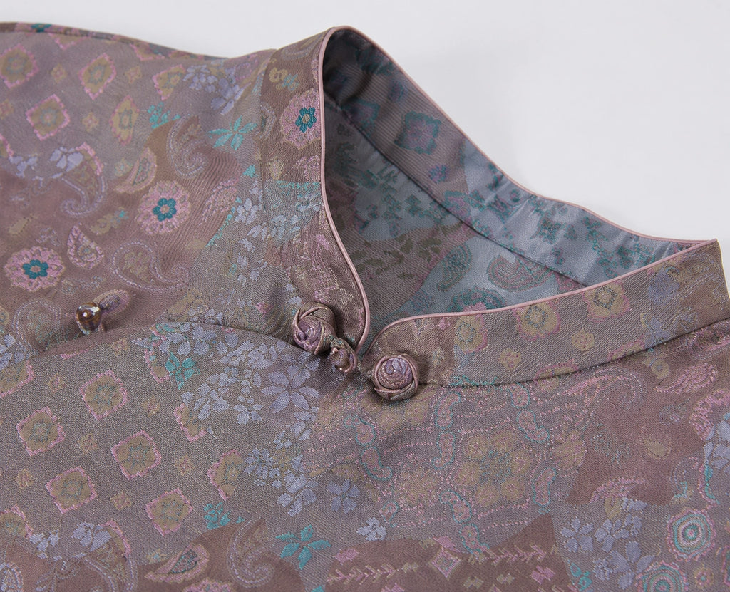 Close-up of the Mandarin collar, knotted frog buttons and intricate multicolor silk pattern.