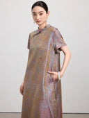 Close view of the multicolor gauze-weave silk dress showing its Mandarin collar, short sleeve and side pocket.