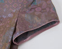 Close-up of the short sleeve and contrast piping on the patterned 100% mulberry silk dress.