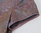 Close-up of the short sleeve and contrast piping on the patterned 100% mulberry silk dress.