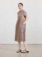 Model wearing an iridescent mauve taupe 100% mulberry silk A-line dress with a Mandarin collar and short sleeves.