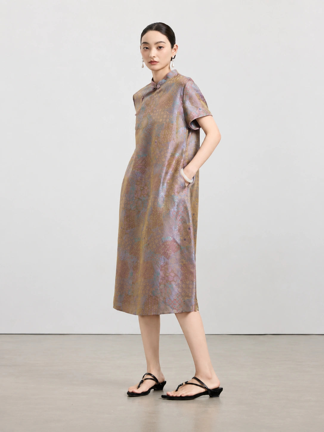Model wearing an iridescent mauve taupe 100% mulberry silk A-line dress with a Mandarin collar and short sleeves.