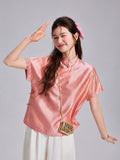 Gambiered Silk coral silk top with a lustrous geometric jacquard pattern and decorative side knot closures