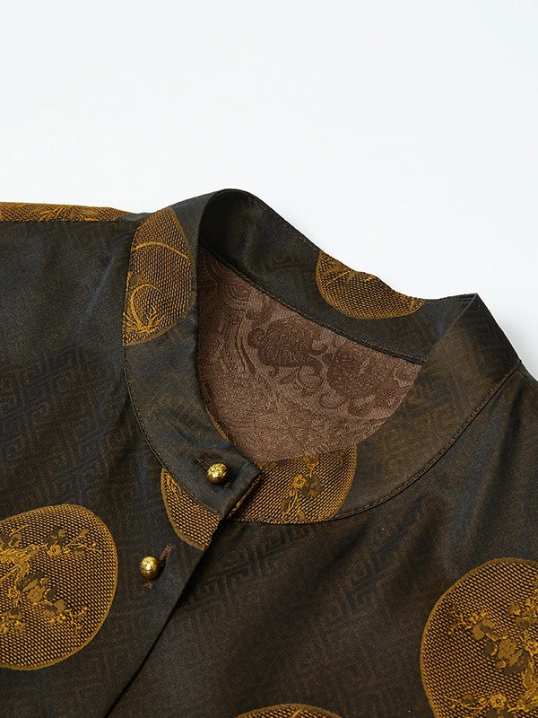 Close-up of an espresso-black silk-blend vest with a stand collar, antique-gold botanical medallions and gold-tone buttons.