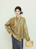 Model wearing a gold and jade green patterned reversible silk jacket with a diagonal front closure