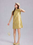 Model wearing a champagne-gold silk shift dress with short sleeves and a Mandarin collar.