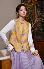 Close-up front view of the golden floral brocade vest with Mandarin collar, multicolor motifs and lavender trim.