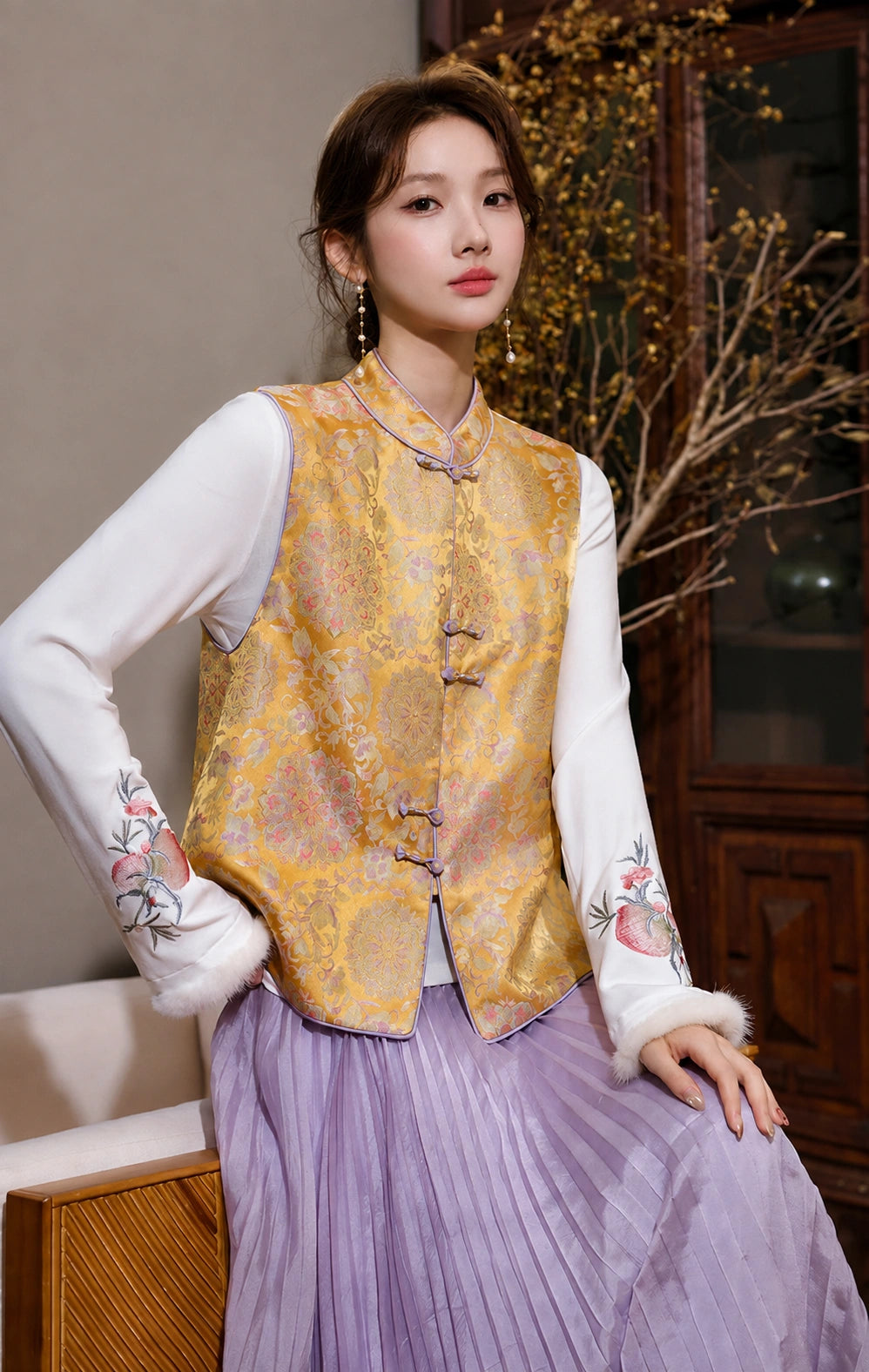 Close-up front view of the golden floral brocade vest with Mandarin collar, multicolor motifs and lavender trim.