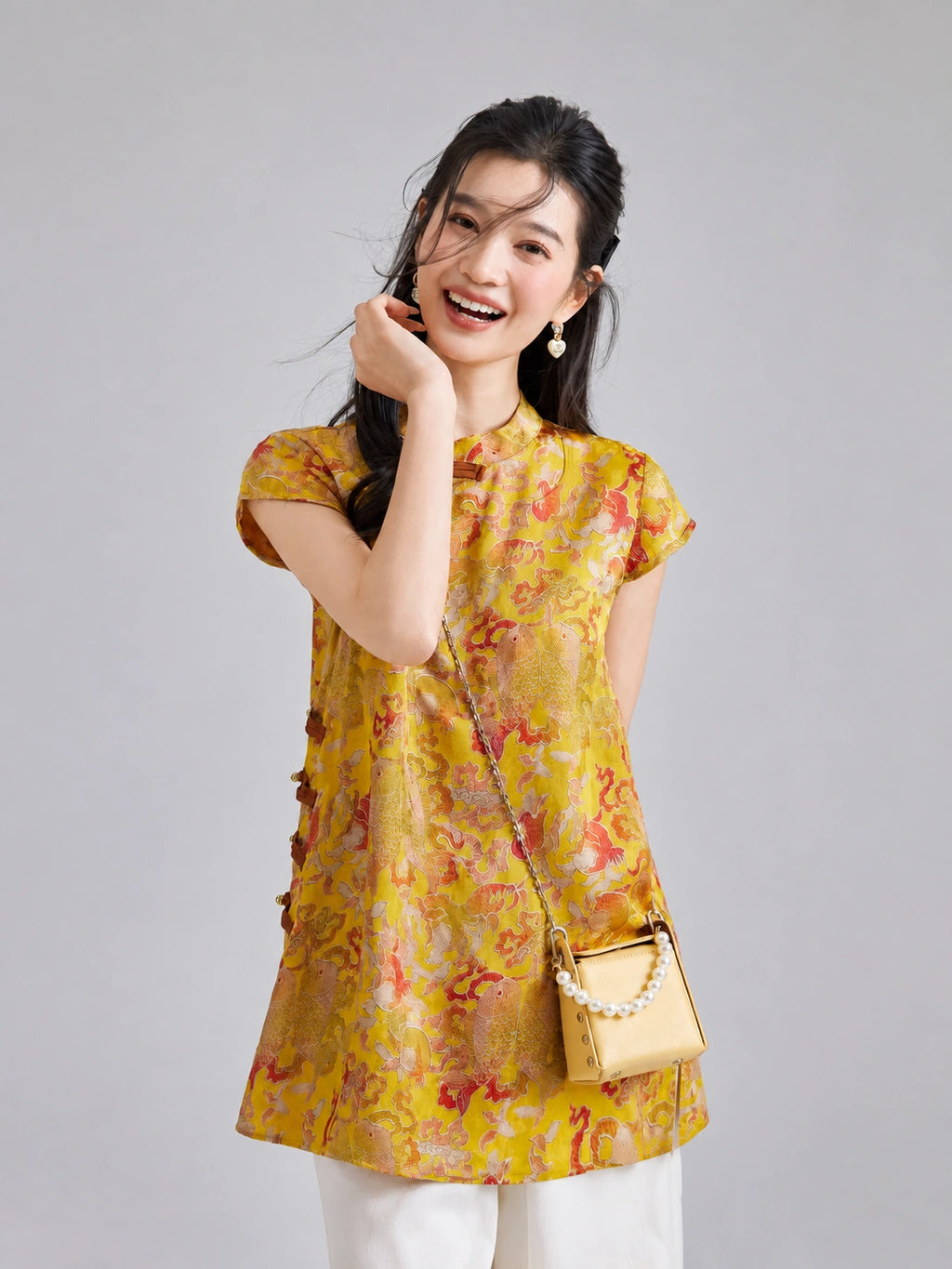 Model wearing a Gambiered Silk golden rayon longline top with botanical and paired-fish motifs