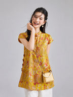 Model wearing a Gambiered Silk golden rayon longline top with botanical and paired-fish motifs