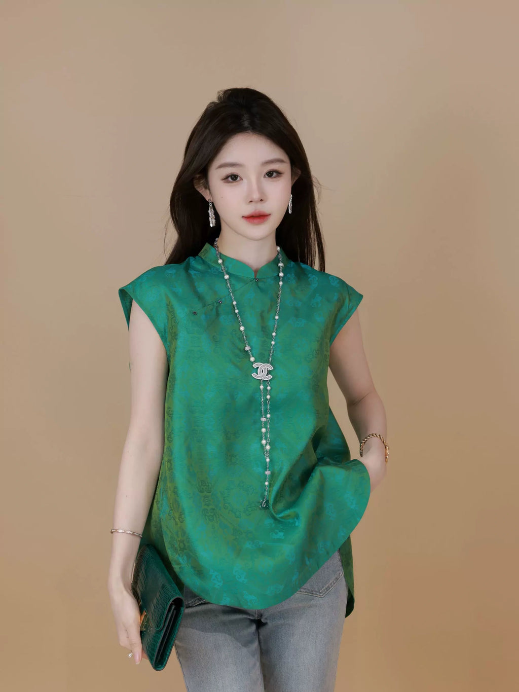 Front view of a relaxed emerald green Chinese-inspired silk top